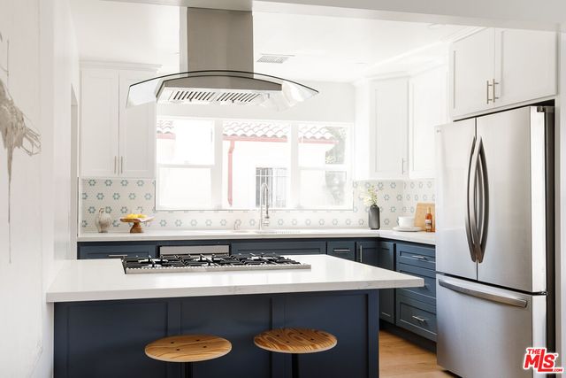 a kitchen with a sink a stove and a refrigerator