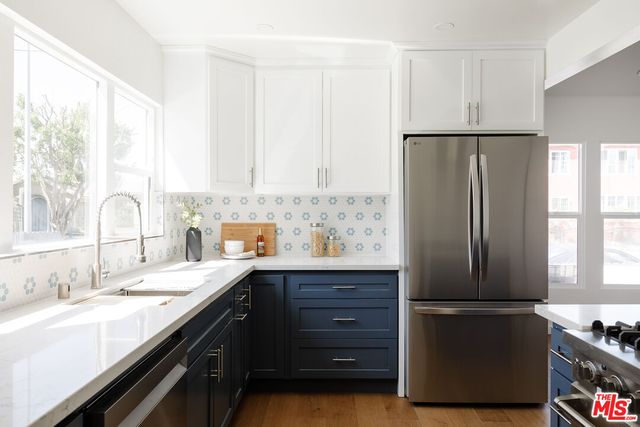 a kitchen with a refrigerator and a sink