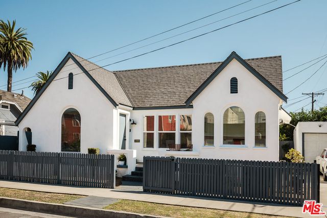 a view of a house with wooden fence