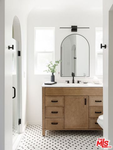 a bathroom with a sink a vanity and a mirror