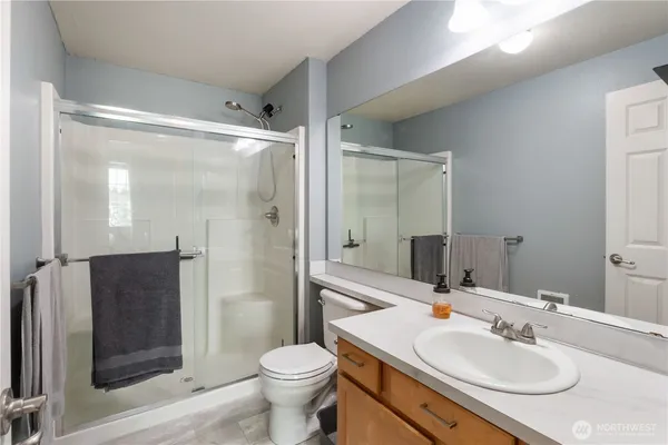 a bathroom with a sink toilet and shower