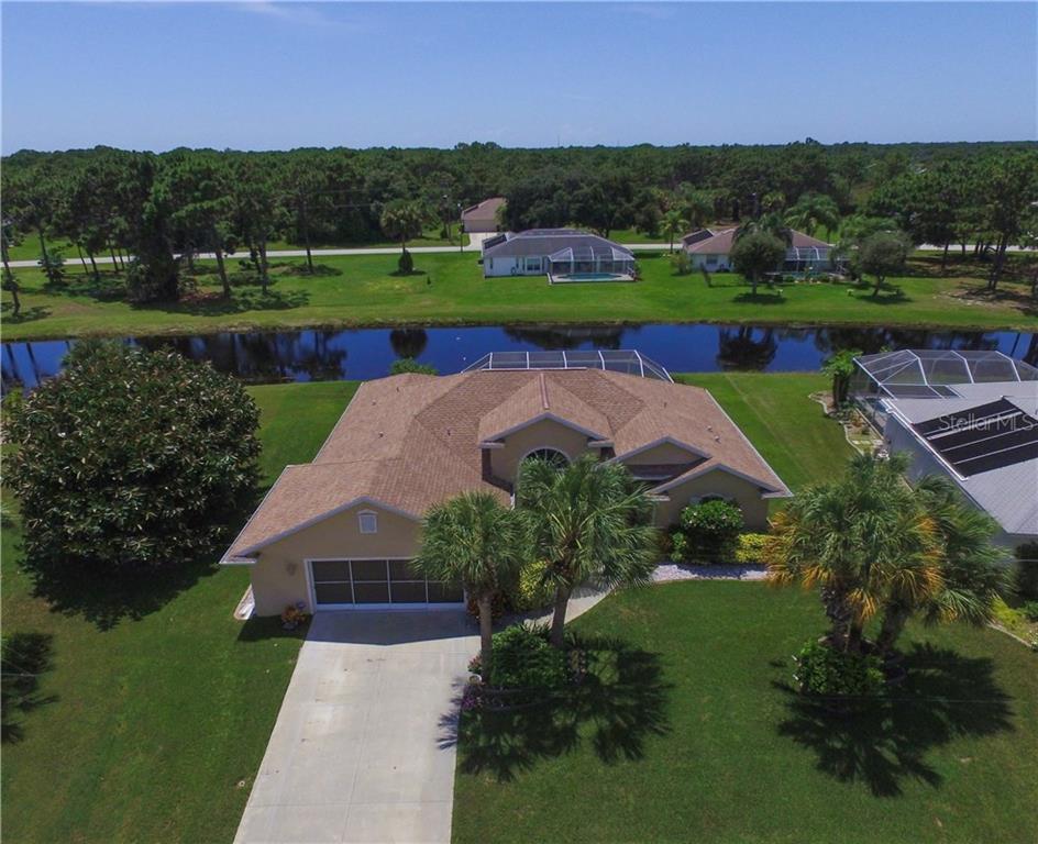 129 Marker Road Rotonda West, FL 33947 - Photo 1 of 1 an aerial view of a house with a garden