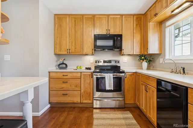 a kitchen with stainless steel appliances a stove microwave and cabinets