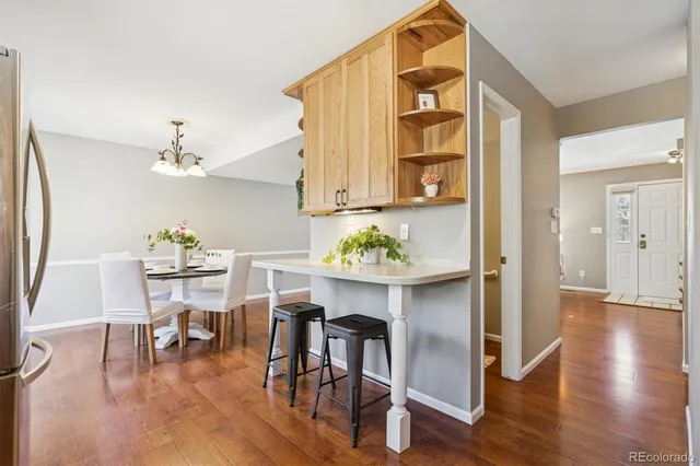 a view of a dining room with furniture and wooden floor