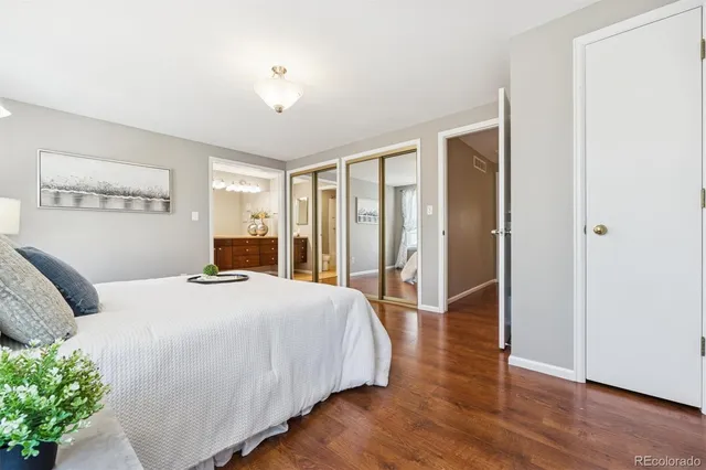 a bedroom with a large bed and a chandelier