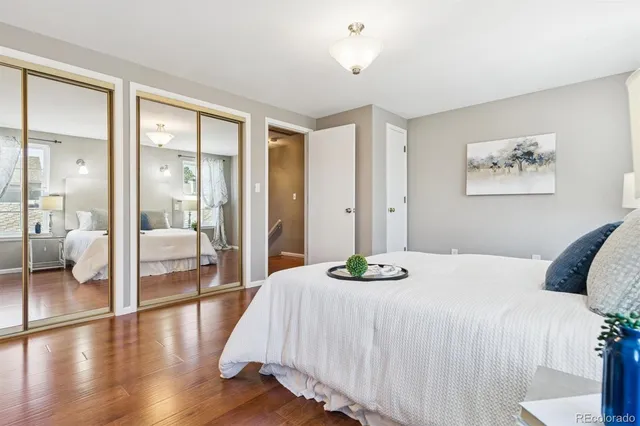 a bedroom with a large bed and a chandelier