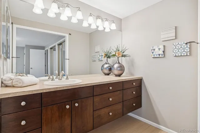 a bathroom with a granite countertop sink and a mirror