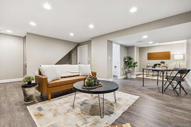 a living room with furniture and wooden floor