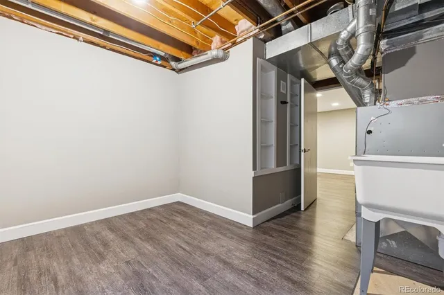 a view of a room with wooden floor