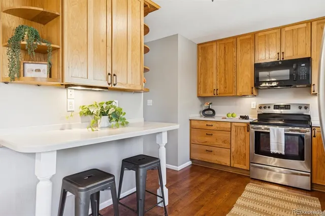a kitchen with stainless steel appliances a stove a sink cabinets and a window