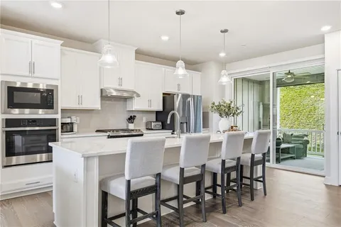 a kitchen with kitchen island a dining table and appliances