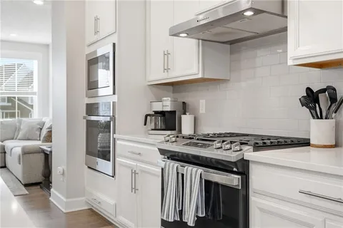 a kitchen with stainless steel appliances granite countertop a stove and a refrigerator