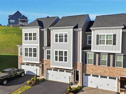 a front view of a residential apartment building with a yard