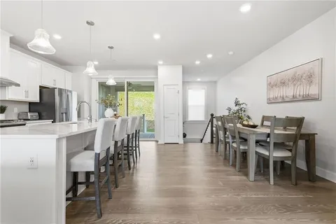 a view of a dining room with furniture window and wooden floor