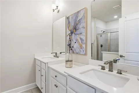 a bathroom with double sink and a mirror