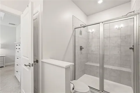 a bathroom with a shower and a toilet