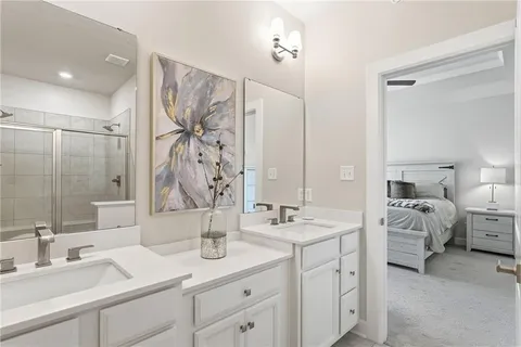 a en suite bathroom with double sink and a mirror