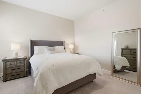 a bedroom with a bed and a lamp