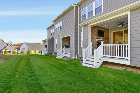 a view of a house with a backyard and a deck