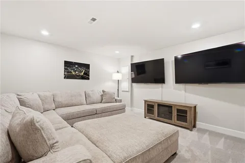 a living room with a flat screen tv and a fireplace
