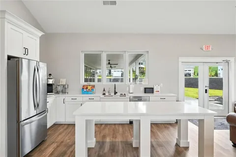 a kitchen with stainless steel appliances a refrigerator and a stove