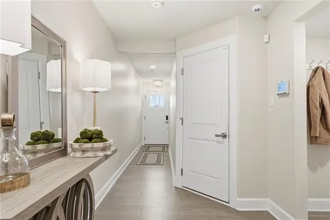 a view of a hallway view with wooden floor and furniture