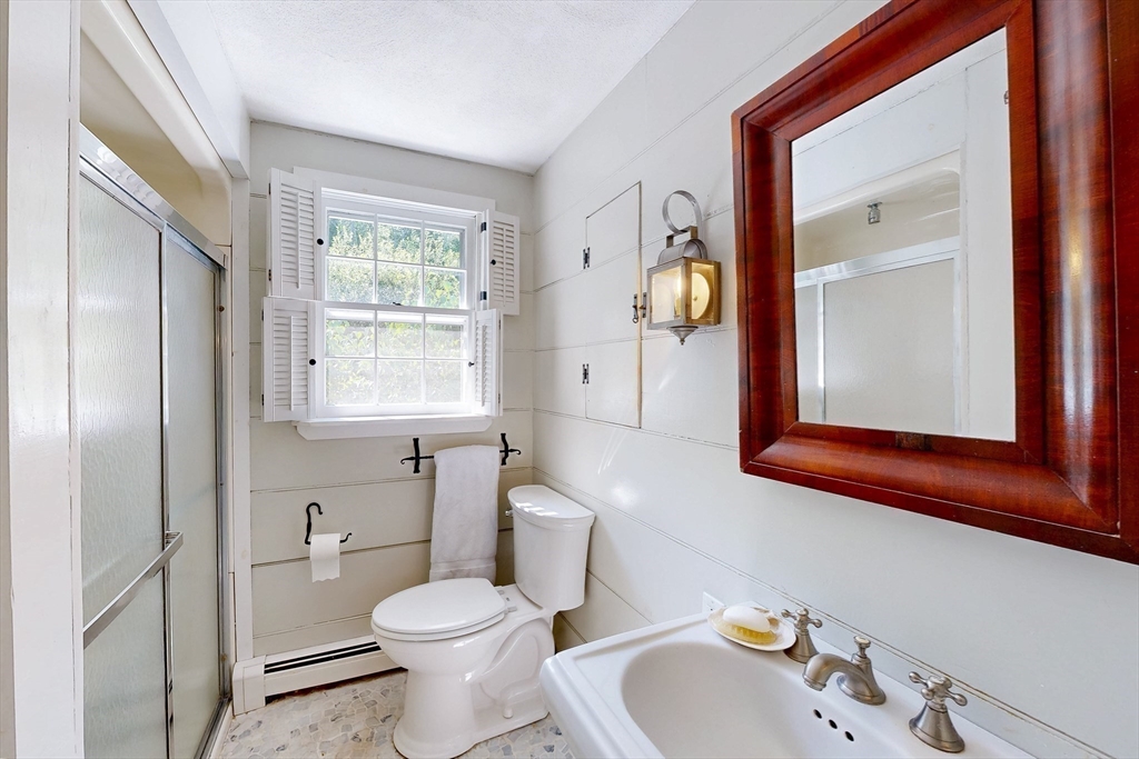3 Spring Valley Road Medfield, MA 02052 - Photo 13 of 21 a bathroom with a sink a mirror and a toilet