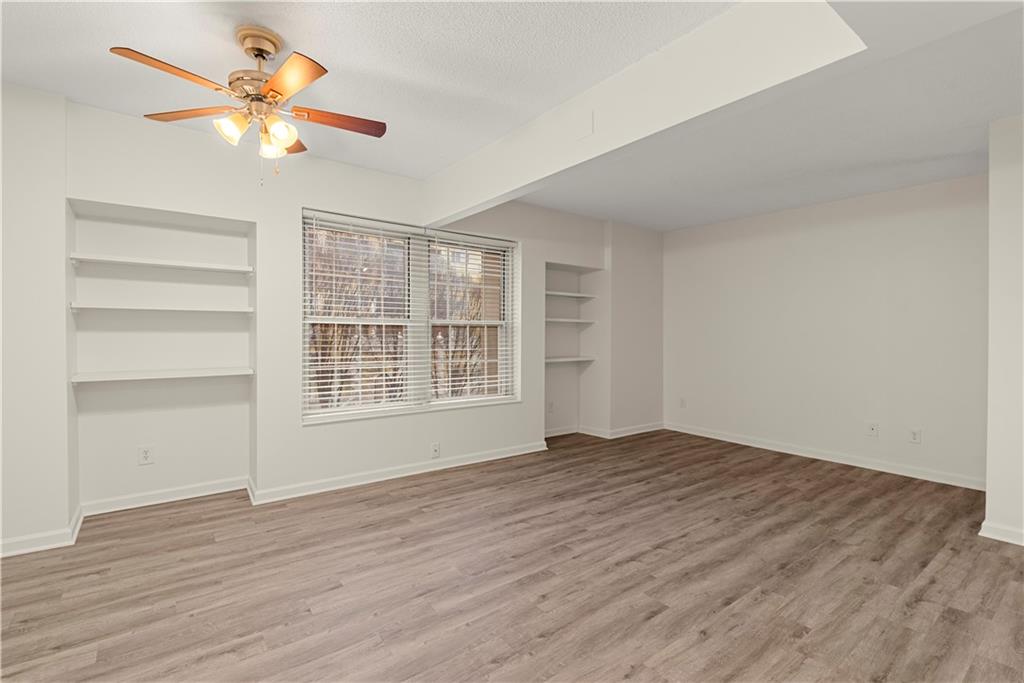 199 14th Street Northeast, Unit 201 Atlanta, GA 30309 - Photo 27 of 42 a view of an empty room with a window and a ceiling fan