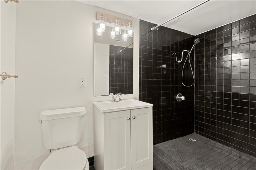 199 14th Street Northeast, Unit 201 Atlanta, GA 30309 - Photo 28 of 42 a bathroom with a toilet sink and shower