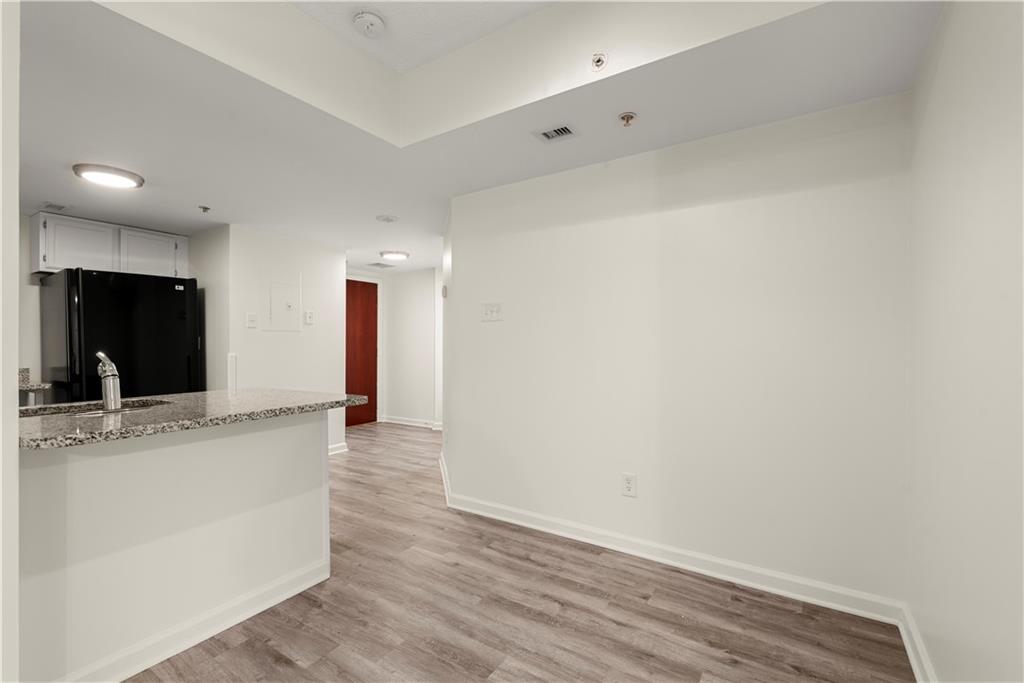 199 14th Street Northeast, Unit 201 Atlanta, GA 30309 - Photo 30 of 42 a view of a kitchen cabinets and wooden floor