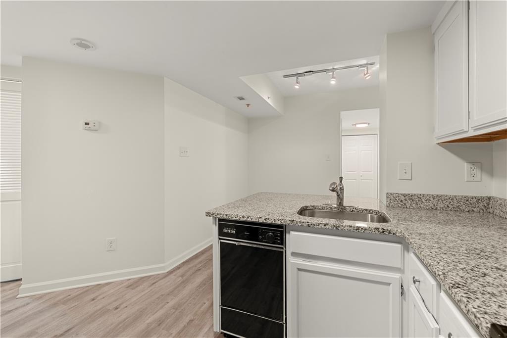 199 14th Street Northeast, Unit 201 Atlanta, GA 30309 - Photo 3 of 42 a room with granite countertop cabinets and oven