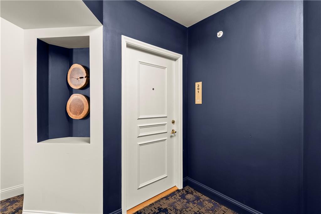 199 14th Street Northeast, Unit 201 Atlanta, GA 30309 - Photo 31 of 42 a view of a hallway with wooden floor