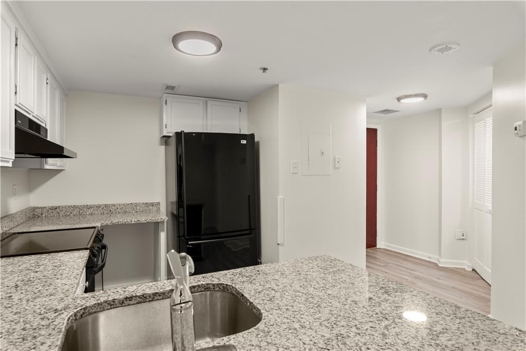 199 14th Street Northeast, Unit 201 Atlanta, GA 30309 - Photo 5 of 42 a kitchen with a sink refrigerator and microwave