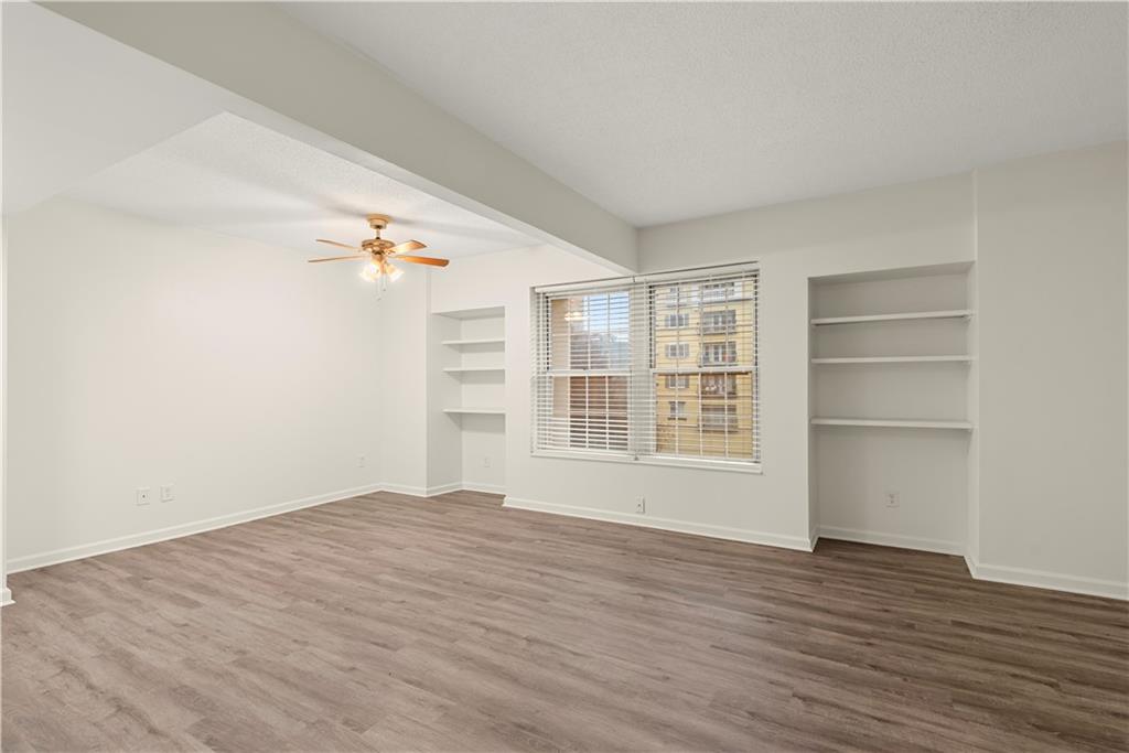 199 14th Street Northeast, Unit 201 Atlanta, GA 30309 - Photo 9 of 42 a view of an empty room with a window and wooden floor
