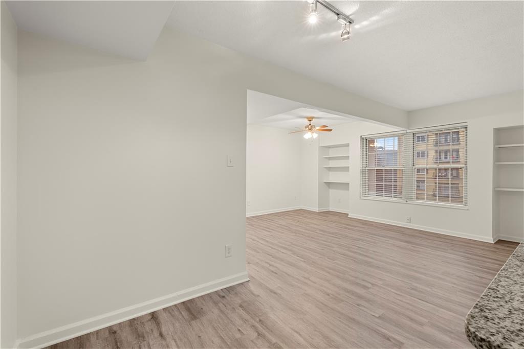 199 14th Street Northeast, Unit 201 Atlanta, GA 30309 - Photo 10 of 42 wooden floor in an empty room with a window