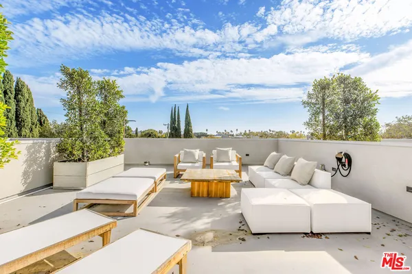a terrace of a house with outdoor seating