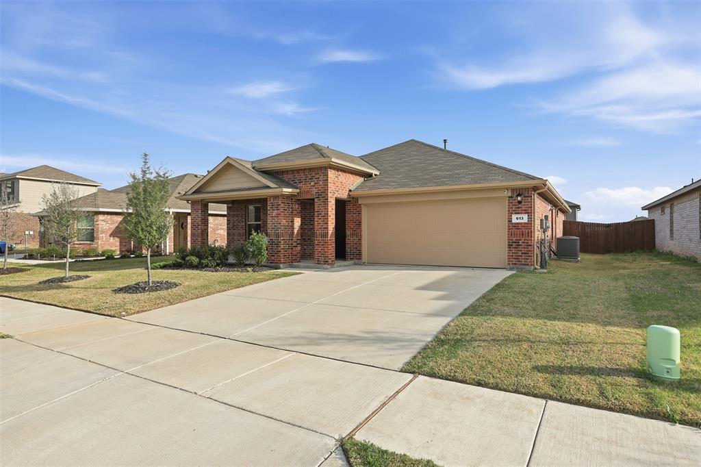 613 Whitecomb Lane Justin, TX 76247 - Photo 1 of 39 a front view of a house with a yard