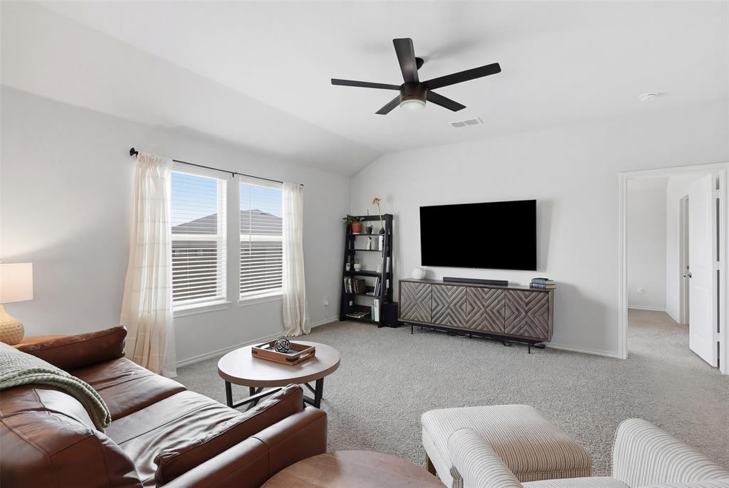 613 Whitecomb Lane Justin, TX 76247 - Photo 13 of 39 a living room with furniture and a flat screen tv