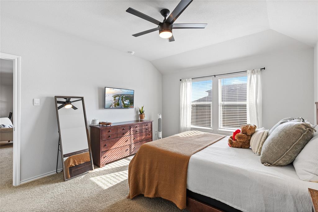 613 Whitecomb Lane Justin, TX 76247 - Photo 16 of 29 a bedroom with a bed a window and dresser