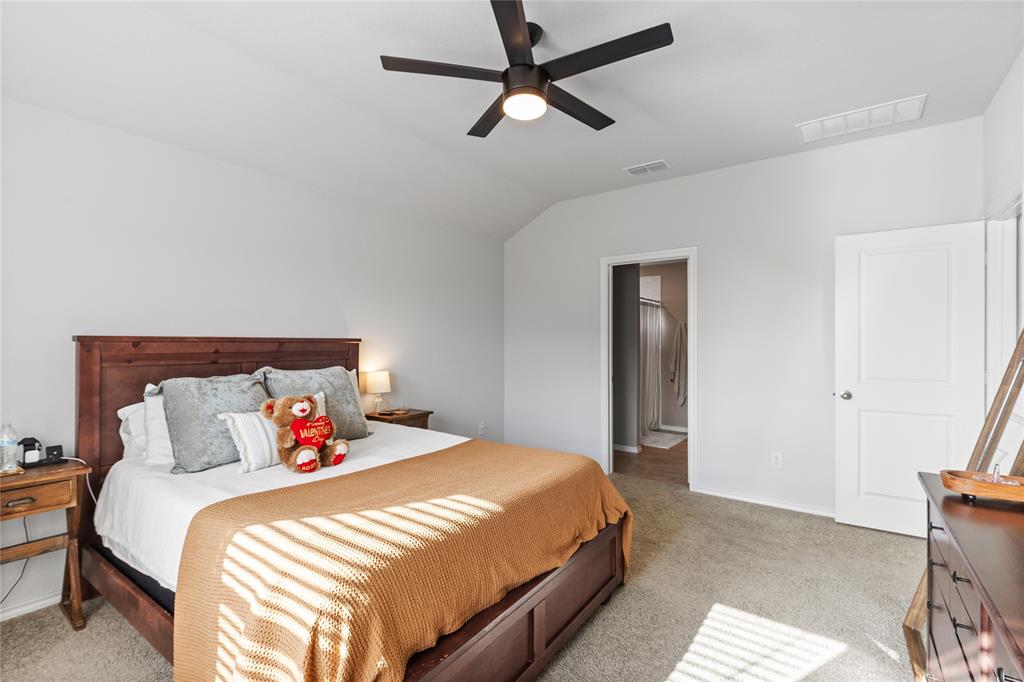 613 Whitecomb Lane Justin, TX 76247 - Photo 17 of 29 a bedroom with a bed and painting on the wall