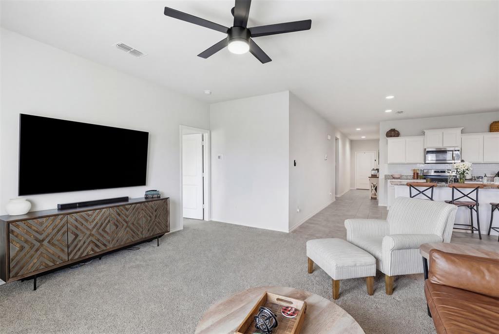 613 Whitecomb Lane Justin, TX 76247 - Photo 17 of 39 a living room with furniture and a flat screen tv