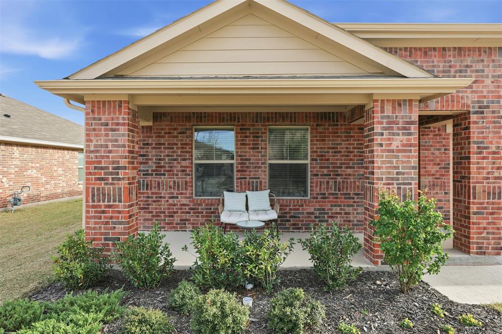 613 Whitecomb Lane Justin, TX 76247 - Photo 2 of 39 a front view of a house with garden