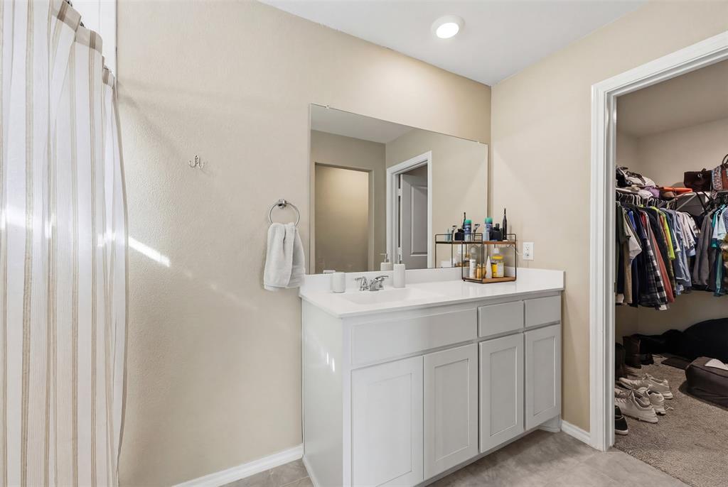 613 Whitecomb Lane Justin, TX 76247 - Photo 21 of 39 a bathroom with a sink and a mirror