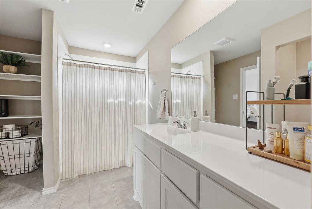 613 Whitecomb Lane Justin, TX 76247 - Photo 22 of 39 a bathroom with a double vanity sink and a mirror
