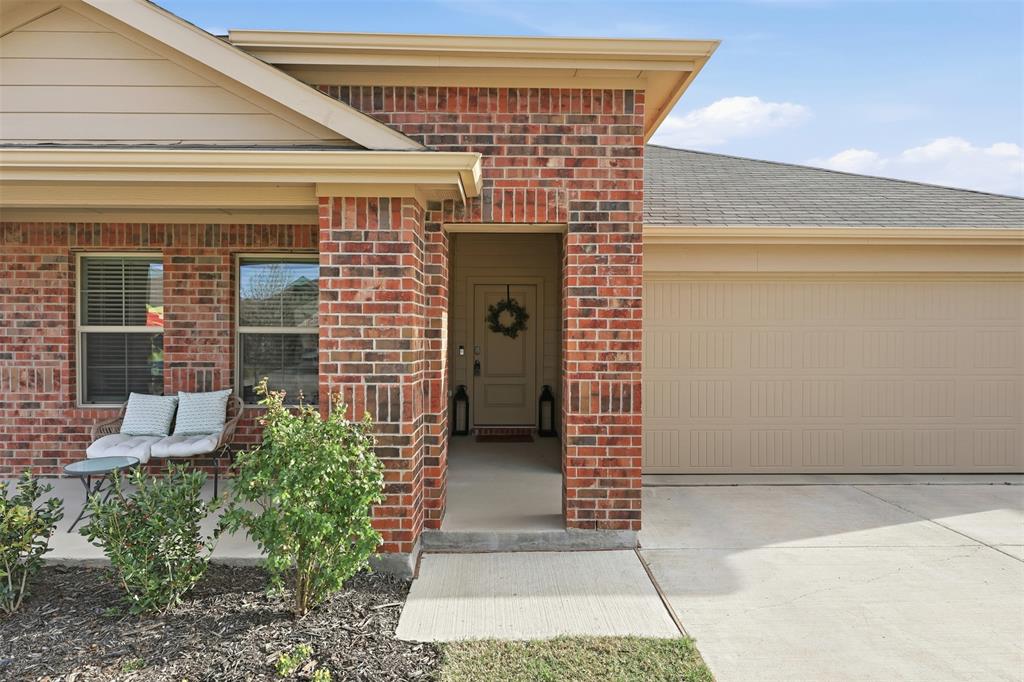 613 Whitecomb Lane Justin, TX 76247 - Photo 29 of 39 a front view of a house with a garage
