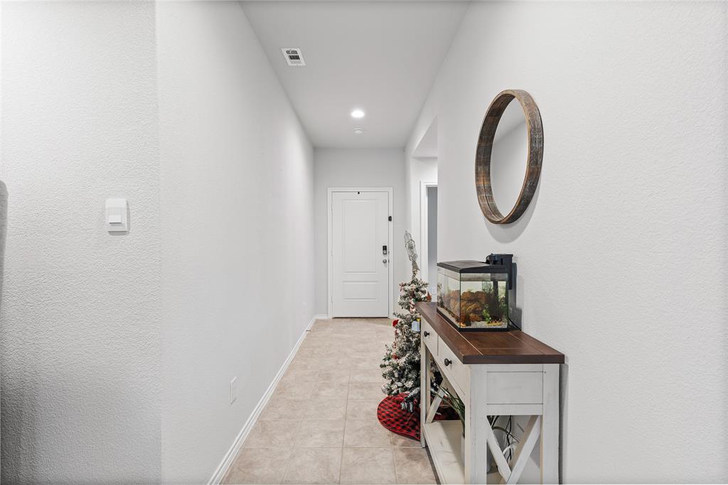 613 Whitecomb Lane Justin, TX 76247 - Photo 3 of 29 a view of a room with rack on the wall