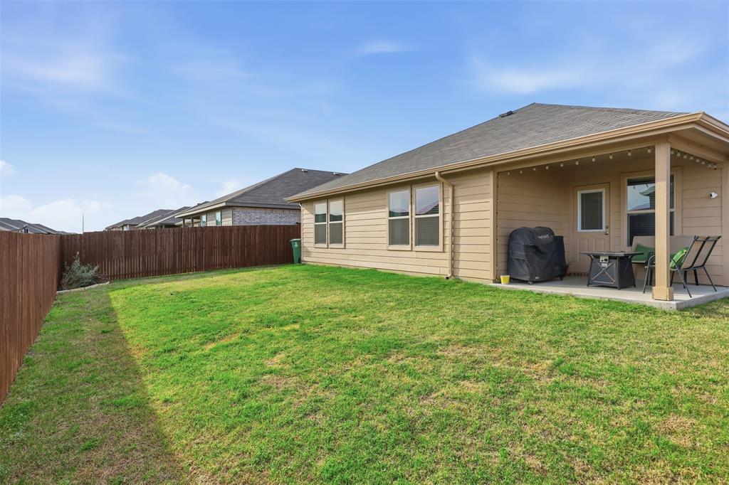 613 Whitecomb Lane Justin, TX 76247 - Photo 32 of 39 a view of a house with yard and a garden
