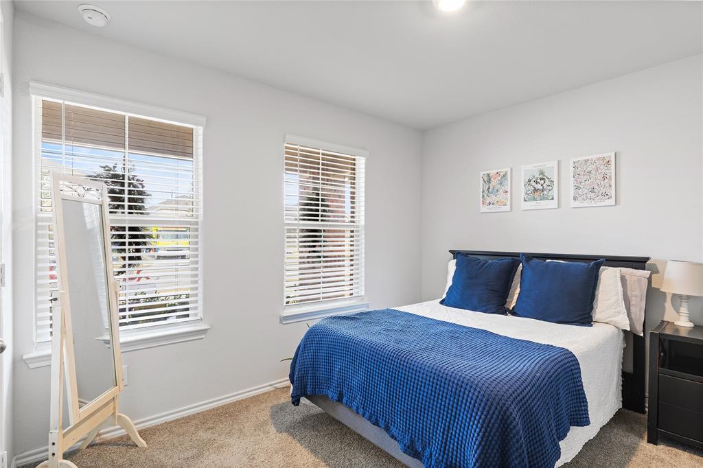 613 Whitecomb Lane Justin, TX 76247 - Photo 4 of 29 a bedroom with a large bed and a window