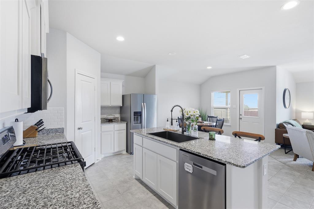 613 Whitecomb Lane Justin, TX 76247 - Photo 5 of 39 a kitchen with a sink stove and refrigerator