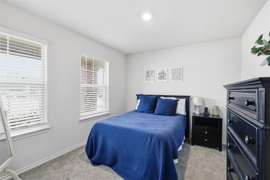 613 Whitecomb Lane Justin, TX 76247 - Photo 6 of 39 a bedroom with a bed and a tv